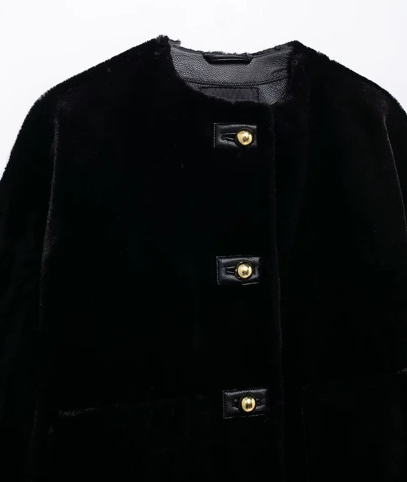 Close-up of a black coat with gold buttons on a white background