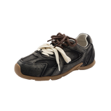 Black sneaker with brown accents on a white background