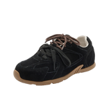 Black sneaker with brown sole on a white background