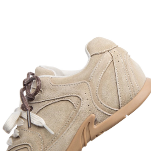 Beige sneaker with white laces on a white background