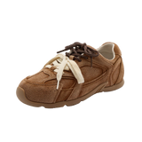 Brown suede sneaker with white laces on a white background