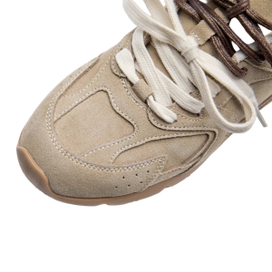 Beige sneaker with white laces on a white background
