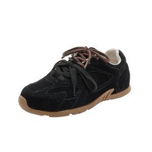 Black sneaker with brown sole on a white background