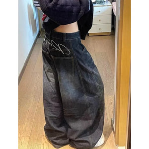 Rock these oversized wide-leg jeans, featuring a distinct curved seam design and faded dark wash for a structured yet relaxed streetwear fit.