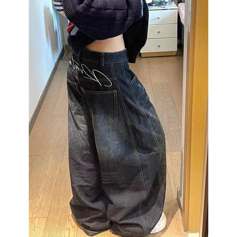 Rock these oversized wide-leg jeans, featuring a distinct curved seam design and faded dark wash for a structured yet relaxed streetwear fit.