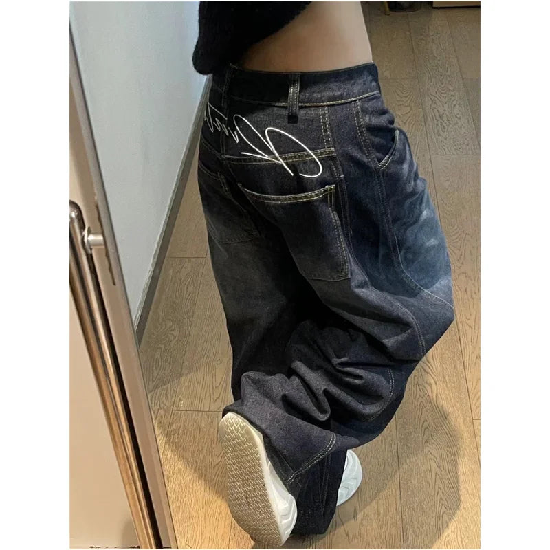 Rock these oversized wide-leg jeans, featuring a distinct curved seam design and faded dark wash for a structured yet relaxed streetwear fit.