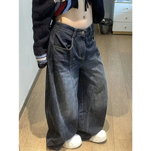 Rock these oversized wide-leg jeans, featuring a distinct curved seam design and faded dark wash for a structured yet relaxed streetwear fit.