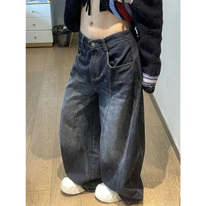 Rock these oversized wide-leg jeans, featuring a distinct curved seam design and faded dark wash for a structured yet relaxed streetwear fit.