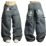 Pair of baggy jeans with branding on a wooden floor.