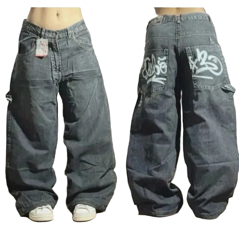 Pair of baggy jeans with branding on a wooden floor.