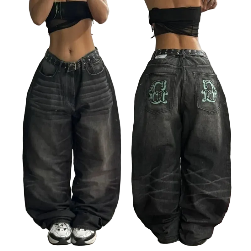 Black distressed jeans with green lettering on a plain background
