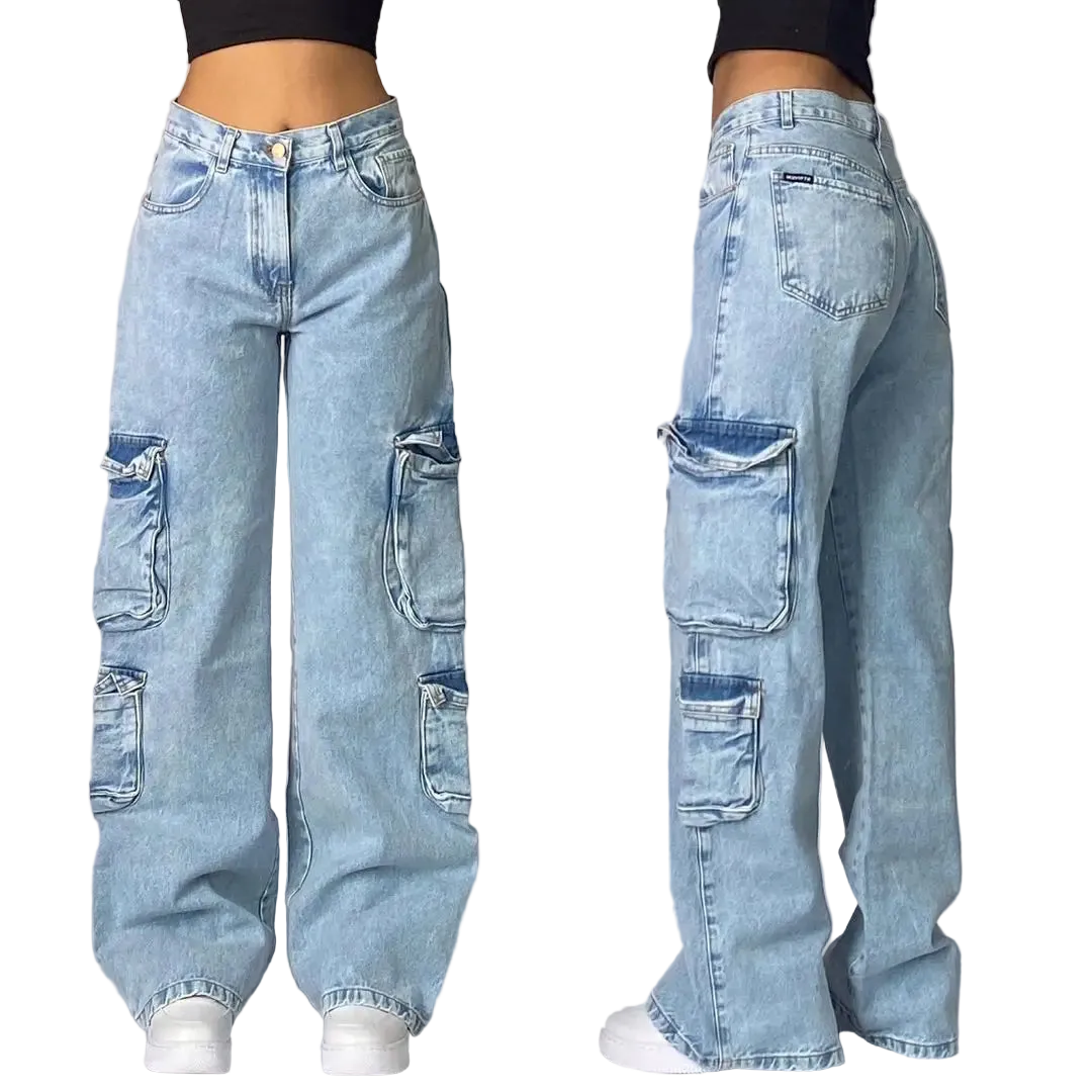 Light blue jeans with patchwork design worn by a person on a gray background