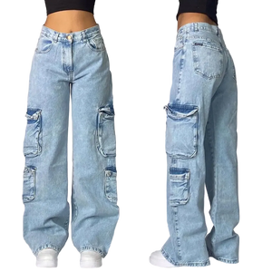 Light blue jeans with patchwork design worn by a person on a gray background