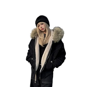 Person wearing a black coat with fur-lined hood and scarf, standing outdoors.