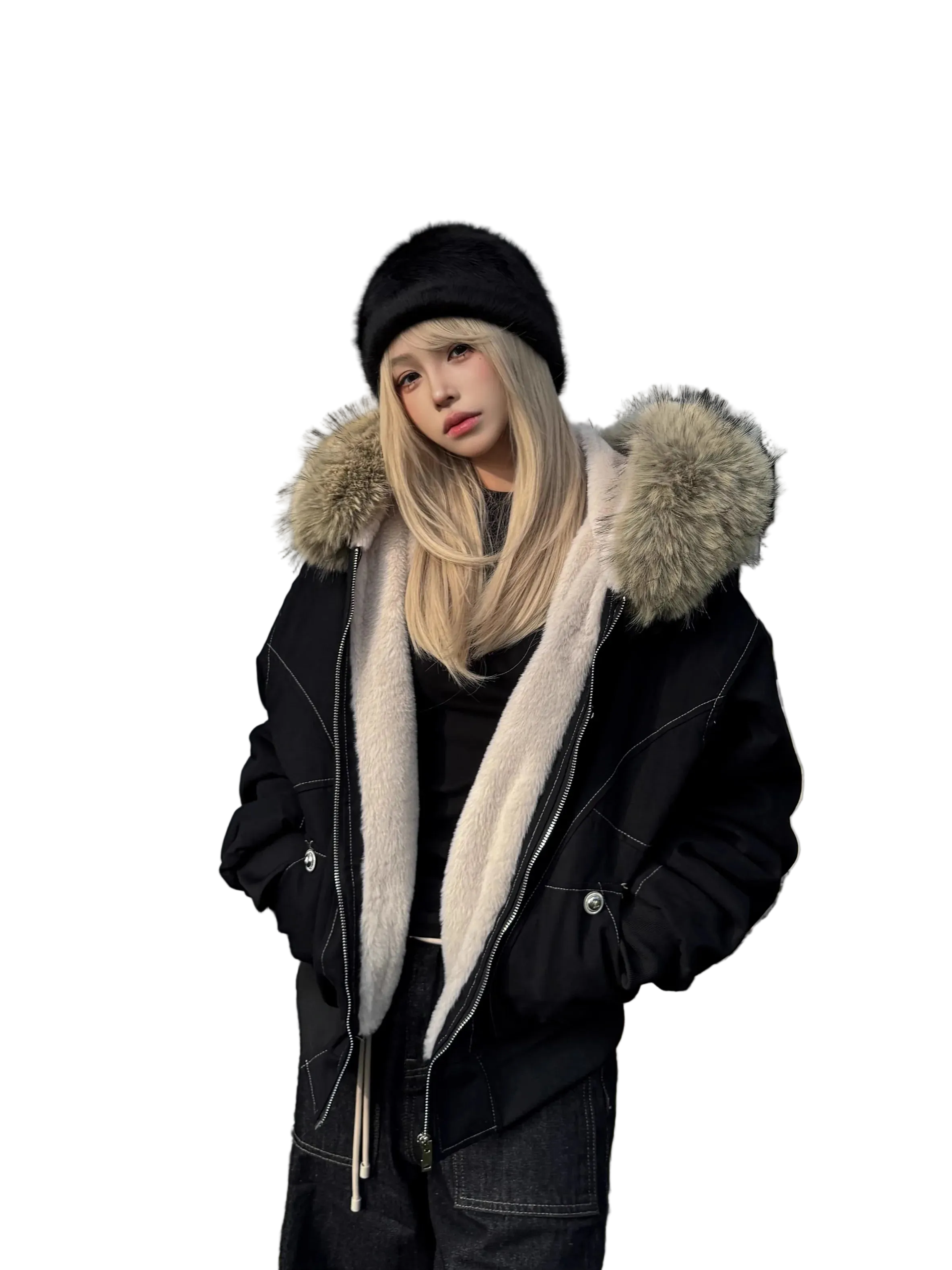 Person wearing a black coat with fur-lined hood and a black beanie outdoors.